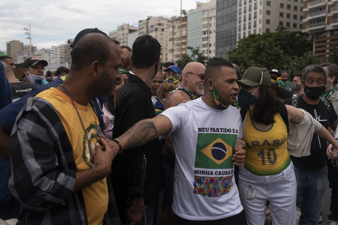 Supporters of Brazilian President Jair Messias Bolsonaro gather in support of him and to protest against racism and the death of blacks in the slums of Brazil during a Black Lives Matter protest on Copacabana beach in Rio de Janeiro on June 7, 2020.