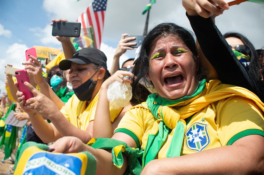 A supporter of Brazilian President Jair Bolsonaro cries during a demonstration in favor of his government amidst the coronavirus pandemic in front of Planalto Palace on May 24, 2020 in Brasilia, Brazil. 