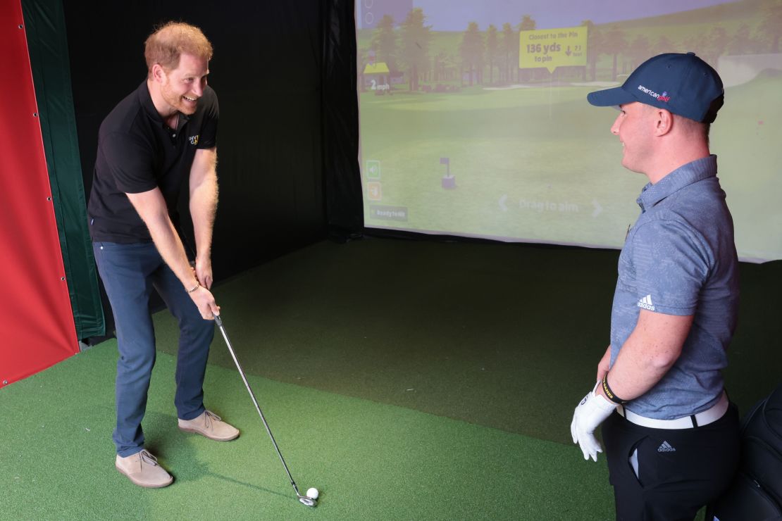 Prince Harry gets a golf lesson from Lawlor.
