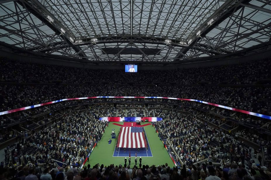 A US flag is unfurled during the opening ceremony for the US Open women's singles final.