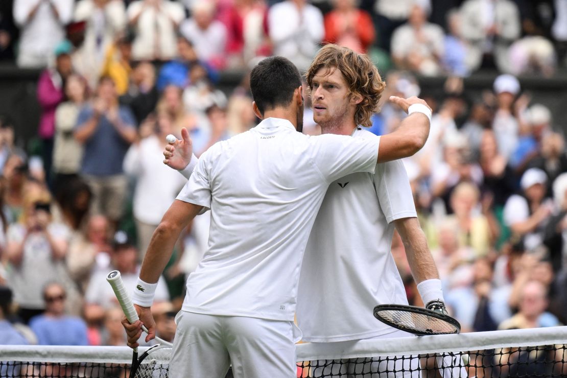 Novak Djokovic and Andrey Rublev embrace after their thrilling clash.