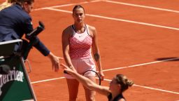 PARIS, FRANCE - MAY 28: Marta Kostyuk of Ukraine shakes hands with the umpire before avoiding shaking hands with Aryna Sabalenka as she looks on after their Women's Singles First Round Match on Day One of the at Roland Garros on May 28, 2023 in Paris, France. (Photo by Julian Finney/Getty Images)