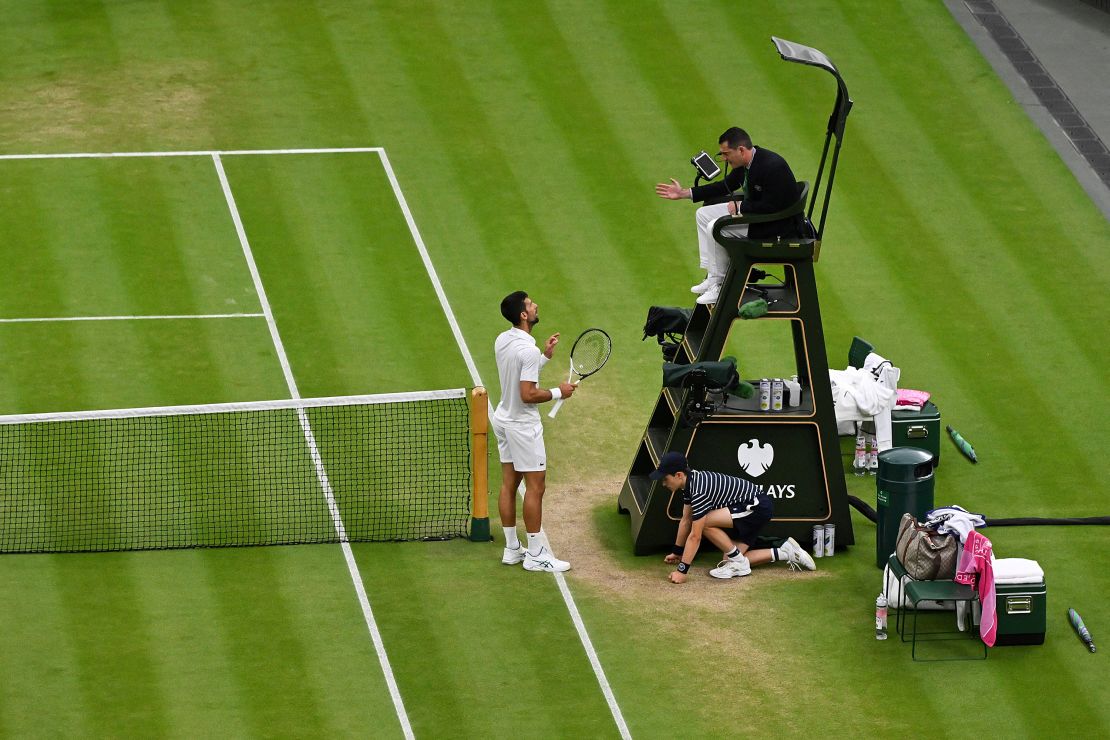 Djokovic argues with the umpire following a point deduction for shouting.