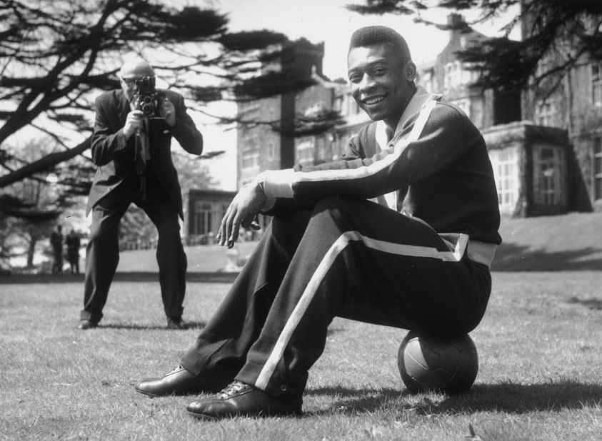 Pelé sits on a ball during a break in training in 1963. The Brazilian national team was in London to play a match against England.