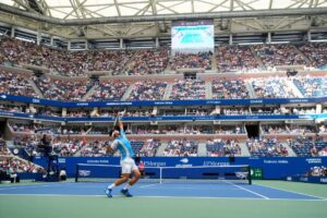Serbian tennis player Novak Djokovic defeats American standout Taylor Fritz to advance to the semifinals of the US Open and commemorates the victory with a group sing-along.
