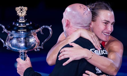 Aryna Sabalenka embraces her fitness trainer Jason Stacy after victory