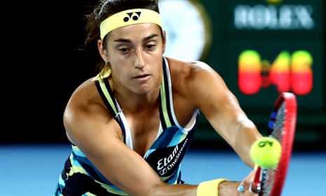 A focused Caroline Garcia hits a backhand return to Naomi Osaka.