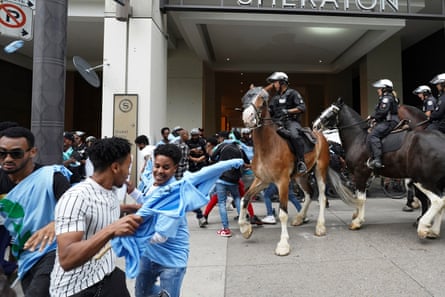 Police push people back during a protest outside the Sheraton Hotel in Toronto after the city revoked a permit for an Eritrean cultural festival scheduled to run in August.