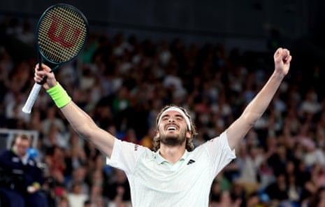 Stefanos Tsitsipas with his arms aloft in celebration