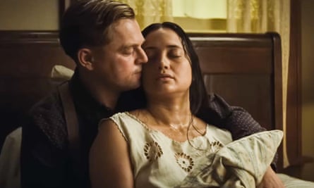 Leonardo DiCaprio in a bed with his arms around a sick-looking Lily Gladstone. 