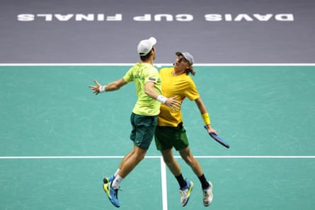 Matthew Ebden and Max Purcell do a chest bump on court