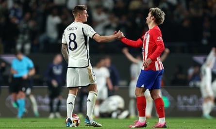 Toni Kroos and Antoine Griezmann clasp hands at full time