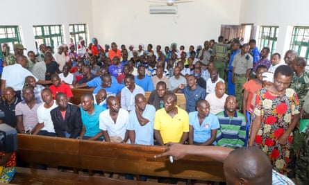 Paul Nthenge Mackenzie (front row, far right) sits along with other defendants in court in Mombasa