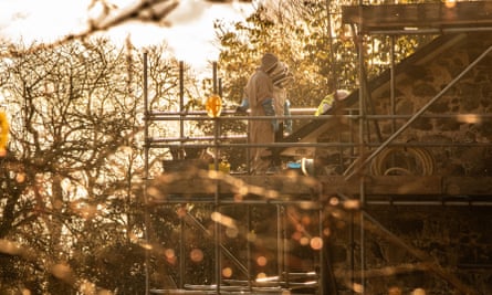 Honeybees are relocating as a house in Wales, owned by the National Trust, undergoes a roof replacement.