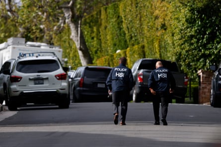 law enforcement officials walk on a street