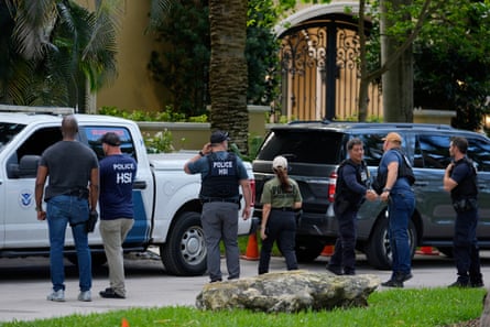 Law enforcement agents stand at the entrance to a property belonging to Sean ‘Diddy’ Combs on Star Island in Miami Beach, Florida.