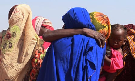 Women from Geneina weeping after receiving news of their missing relatives in Ardamata, as they waited for them in Adré, Chad