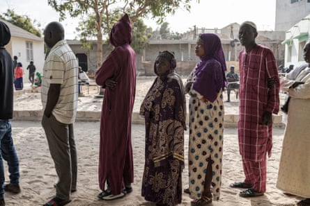 People line up to vote in the presidential election in Dakar, Senegal