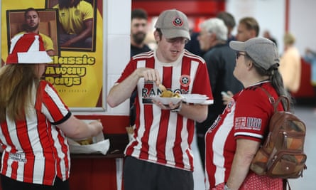 Fans eating chips before the Premier League match between Sheffield United and Manchester City last August