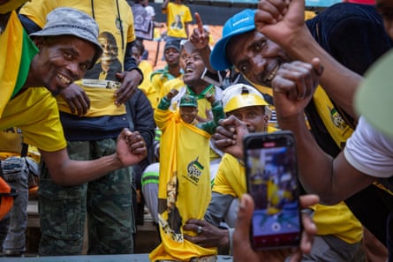 Supporters hold a figurine of Nelson Mandela during the ANC rally in Soweto