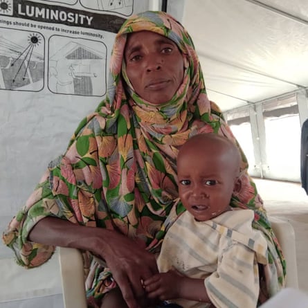 Kalouma Adam Khatir with one of her children in the Zamzam camp.