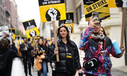 People march with signs showing a clenched fist.