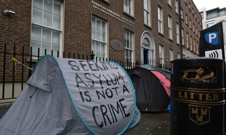 A grey tent with ‘seeking asylum is not a crime’ written on its side