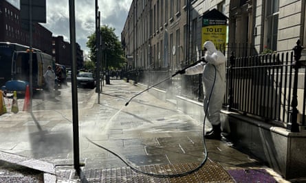 Worker cleans a street in central Dublin