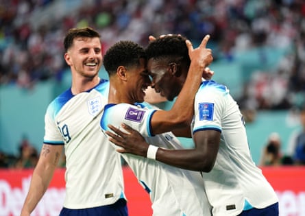 Bukayo Saka and Jude Bellingham celebrate a goal with Mason Mount during England’s World Cup win against Iran in 2022.