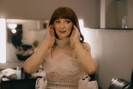 Nicola Roberts standing in a dressing room wearing a pale embellished stage costume