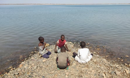 Children sit on the bank of the river Seteit in Gadaref state in eastern Sudan