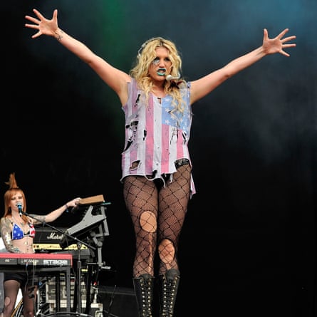 Keisha in ripped stars-and-stripes top and ripped net tights and blue lipstick