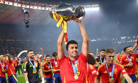 Rodri lifts the European Championship trophy in celebration after Spain’s victory in the final.