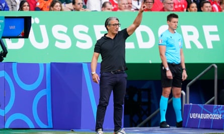 Murat Yakin waves his hand at a football match. 