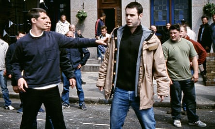 Danny Dyer in The Football Factory, surrounded by aggressive looking men outside a pub