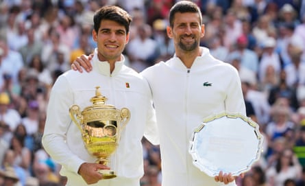 Carlos Alcaraz (left) holds the Wimbledon men’s singles trophy after defeating Novak Djokovic (right) in the final