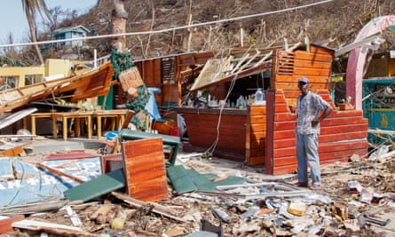 Man stands next to wreckage of cafe