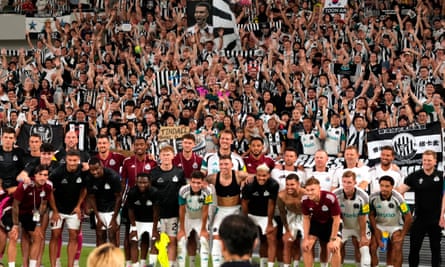 Newcastle players pose with supporters in Tokyo.