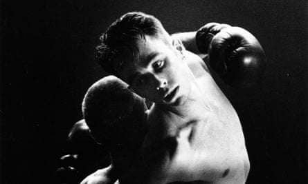 Two men embracing while wearing boxing gloves