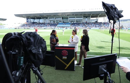 The BBC Sport presenter Alex Scott (left) speaks with pundits Fara Williams (centre) and Ellen White before the WSL game between Manchester City and Arsenal in May