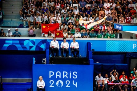 Judges and fans watch a Chinese diver in action during the women’s diving 10m platform final.