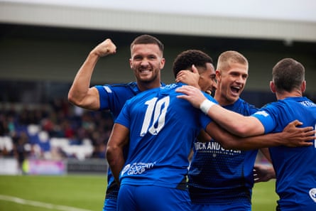 Danny Elliott (10) scores and then celebrates with his teammates as Macclesfield FC win convincingly.