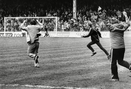 David Pleat runs on to the Maine Road pitch at the final whistle after Luton’s victory meant they avoided relegation to the Second Division and sent down Manchester City instead