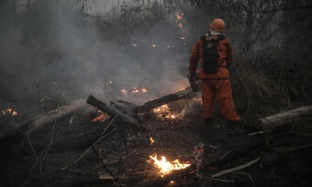 a firefighter wearing orange battles flames