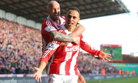 Peter Odemwingie gives Stephen Ireland a lift after scoring for Stoke against West Ham in 2014.