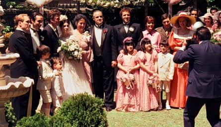 A family group posing for a wedding photographer in