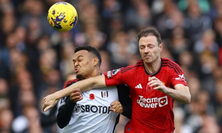 Manchester United’s Jonny Evans fights for possession against Fulham’s Rodrigo Muniz