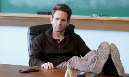 a man sitting at a desk with his feet on the table