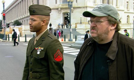 film still of man in military uniform on a street next to a man in a baseball cap