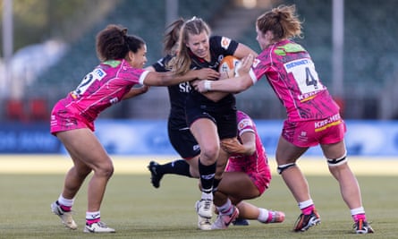 Zoe Harrison of Saracens is tackled by Tatyana Heard and Kate Williams of Gloucester-Hartpury.